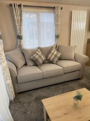 a living room with a couch and a window at 3 BR - Luxury Family Home Near The Beach in East Mersea