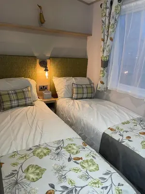 a bedroom with two beds and a window at 3 BR - Luxury Family Home Near The Beach in East Mersea