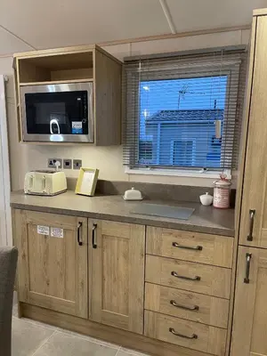 a kitchen with a counter with a microwave and a window at 3 BR - Luxury Family Home Near The Beach in East Mersea