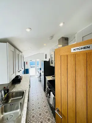 a kitchen with a sink and a counter top at Sun Guest House Cambridge in Cambridge