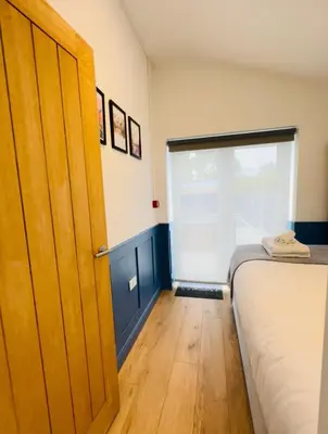 a bedroom with a bed and a large window at Sun Guest House Cambridge in Cambridge