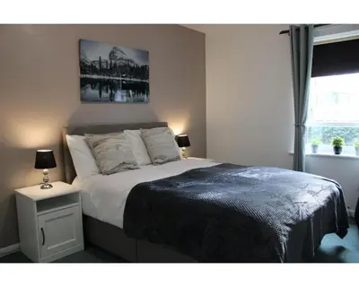 a bedroom with a large bed and a window at A Comfortable Nest for Contractors or Families - sleeps 8 in Chesterton