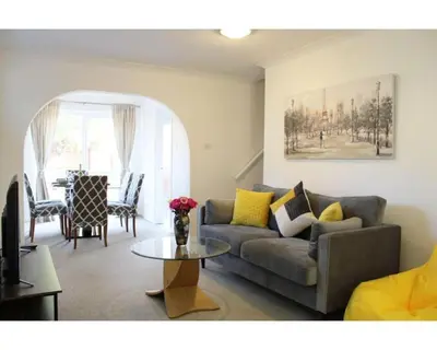 a living room with a couch and a table at A Comfortable Nest for Contractors or Families - sleeps 8 in Chesterton