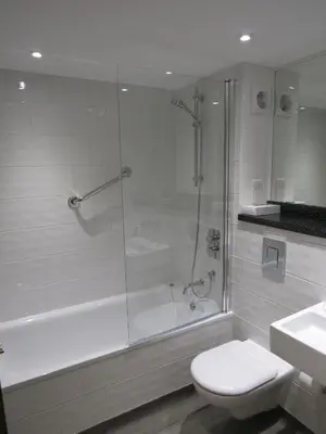 a bathroom with a shower and a toilet and a sink at Ufford Park Resort in Woodbridge