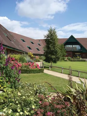 a building with a bunch of flowers in front of it at Ufford Park Resort in Woodbridge