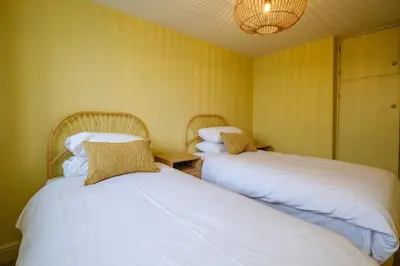 two beds sitting next to each other in a room at Coastguards in Aldeburgh