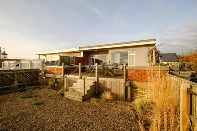 a small house with a fence and a patio at Coastguards in Aldeburgh