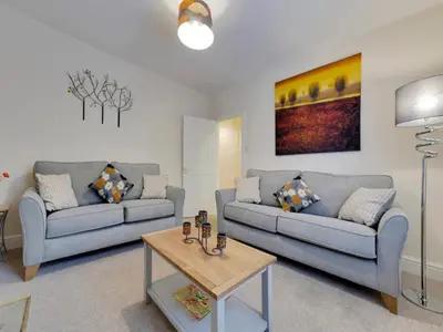 a living room with two couches and a coffee table at Pass the Keys Modern and Spacious Terrace in Central Cambridge in Cambridge