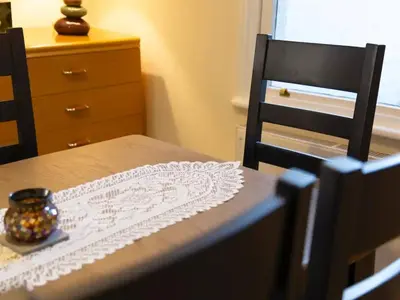 a dining room table with a lace table cloth on it at Pass the Keys Modern and Spacious Terrace in Central Cambridge in Cambridge