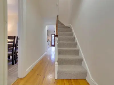a stairway in a home with white walls at Pass the Keys Modern and Spacious Terrace in Central Cambridge in Cambridge