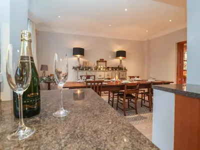 a bottle of wine sitting on a counter with two wine glasses at 42 Crag Path in Aldeburgh
