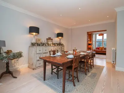 a dining room with a wooden table and chairs at 42 Crag Path in Aldeburgh