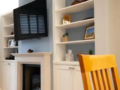 a living room with a tv and a fireplace at Pass the Keys Centrally located modern and spacious 3 Bed terrace in Cambridge