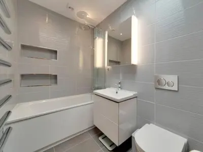 a white bathroom with a toilet and a sink at Pass the Keys Centrally located modern and spacious 3 Bed terrace in Cambridge