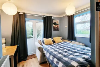 a bedroom with a bed and a window at The Rose Garden of Basildon in the Heart of Basildon by Artisan Stays I Weekly or Monthly Stay Offer I Pvt Parking I Sleeps 6 in Basildon