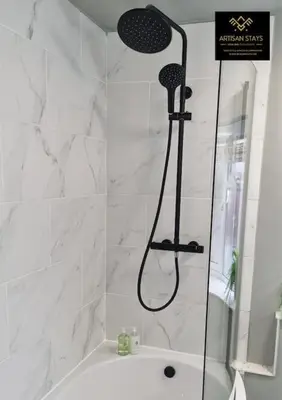 a shower in a bathroom with a bath tub at The Rose Garden of Basildon in the Heart of Basildon by Artisan Stays I Weekly or Monthly Stay Offer I Pvt Parking I Sleeps 6 in Basildon