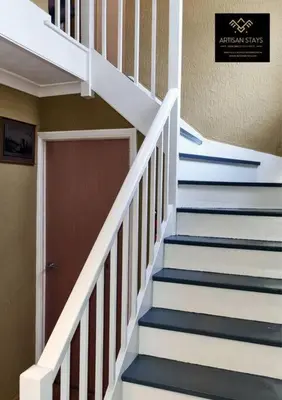 a set of stairs with a door in a house at The Rose Garden of Basildon in the Heart of Basildon by Artisan Stays I Weekly or Monthly Stay Offer I Pvt Parking I Sleeps 6 in Basildon