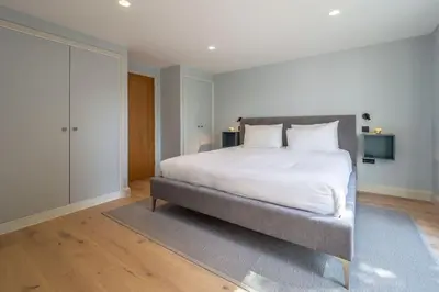 a bedroom with a large bed with white sheets and pillows at Court House, Aldeburgh in Aldeburgh