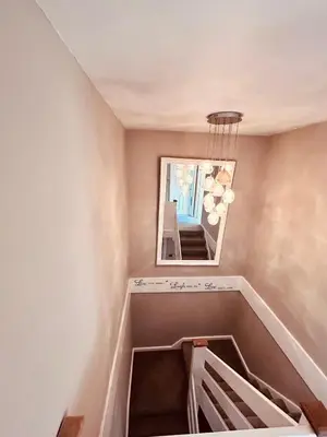 a room with a mirror and a stairwell with a mirror at Stunning 3BR House w/ Parking in Stevenage