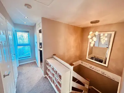 a bathroom with a sink and a mirror on the wall at Stunning 3BR House w/ Parking in Stevenage