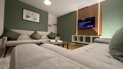 a living room with two couches and a flat screen tv at Long Stay - Free Parking - Contractors - Train Station - Students in Colchester