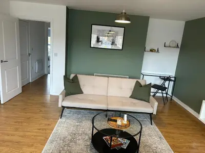 a living room with a couch and a table at Long Stay - Free Parking - Contractors - Train Station - Students in Colchester
