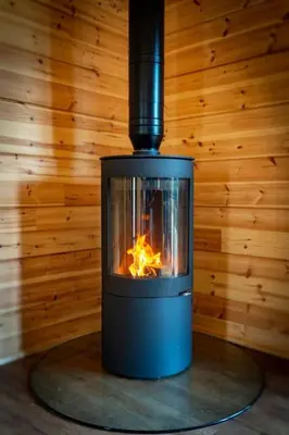 a stove in a room with a fire in it at Meadow Valley Lodge 3 - Hot Tub in Hintlesham