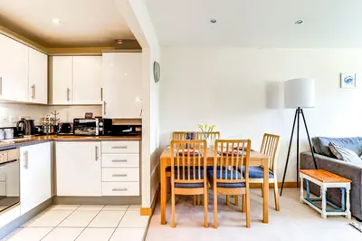 a kitchen and dining room with a table and chairs at Entire 2 Bed Flat Contractors Families and Relocators in Ware