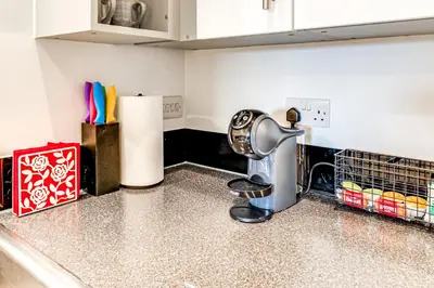 a kitchen counter with a mixer on a counter top at Entire 2 Bed Flat Contractors Families and Relocators in Ware