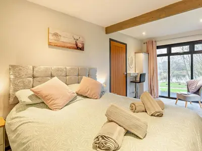 a bedroom with a large bed with two pillows on it at 2 Bed in Norwich oc-73624 in East Harling