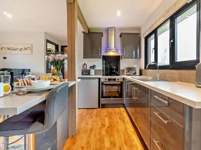 a kitchen with wooden floors and stainless steel appliances at 2 Bed in Norwich oc-73624 in East Harling
