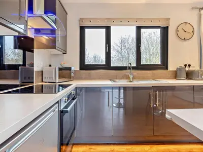 a kitchen with stainless steel appliances and a clock on the wall at 2 Bed in Norwich oc-73624 in East Harling
