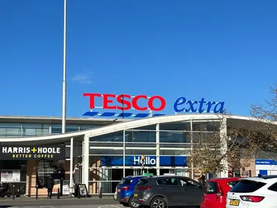 a tesco exit sign on top of a parking lot at Modern 3 bed House with two bathrooms! Free parking! in Bar Hill
