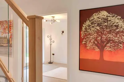 a large painting of a tree on a wall at Kestrel Gardens Dunmow in Great Dunmow