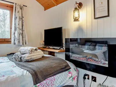 a bedroom with a bed and a flat screen tv at 1 Bed in Norwich oc-57900 in East Harling