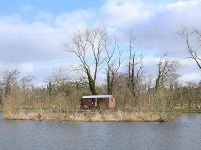a small shack on the side of a body of water at 1 Bed in Norwich oc-57900 in East Harling