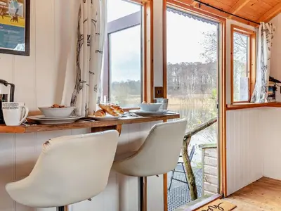 a kitchen with a table and chairs and a window at 1 Bed in Norwich oc-57900 in East Harling