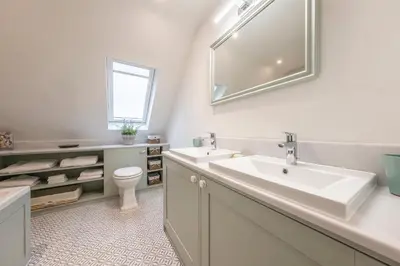 a bathroom with a sink and a toilet at Dedham Vale Cottage with Swimming Pool mid May to mid Sep - Yew Tree Barn in Higham