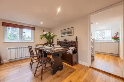 a dining room with a table and chairs at Dedham Vale Cottage with Swimming Pool mid May to mid Sep - Yew Tree Barn in Higham