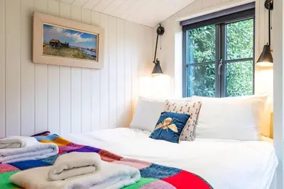 a bedroom with a bed with towels on it at The Little House, Orford in Woodbridge