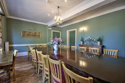 a large dining room with a large table and chairs at Saham Grove Hall by Group Retreats in West Bradenham