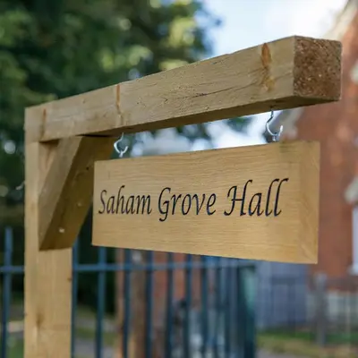 a wooden sign that reads sakura grove hall at Saham Grove Hall by Group Retreats in West Bradenham