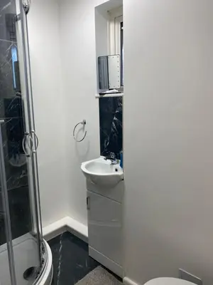 a bathroom with a sink and a toilet and a shower at Jmk home in Lexden