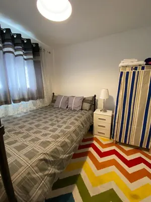 a bedroom with a bed and a rug at Jmk home in Lexden