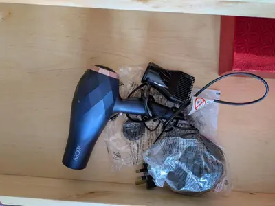 a blow dryer in a plastic bag on a table at Colchester Town, modern, detached, guest house in Colchester