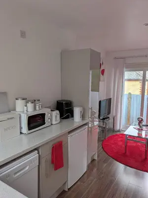a kitchen with a counter top with a microwave at Colchester Town, modern, detached, guest house in Colchester