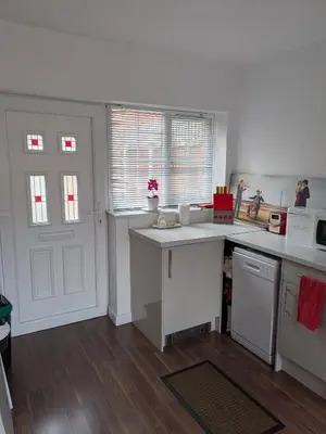 a kitchen with white appliances and a white counter top at Colchester Town, modern, detached, guest house in Colchester