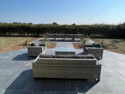 a patio with three couches and a bench at 9 Bed in Ipswich oc-62352 in Freston