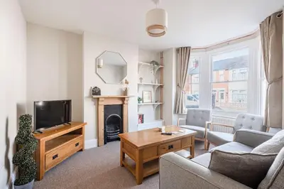a living room with a couch and a tv at Host & Stay - Sherrington Road Abode in Ipswich