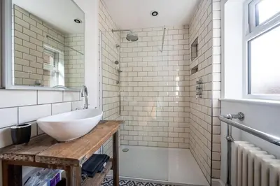 a bathroom with a white sink and a shower at Host & Stay - Sherrington Road Abode in Ipswich